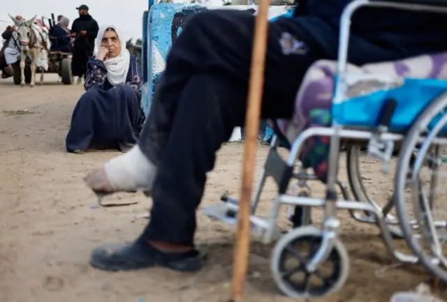 Palestinian patients rest as they arrive in Rafah after they were evacuated from Nasser hospital