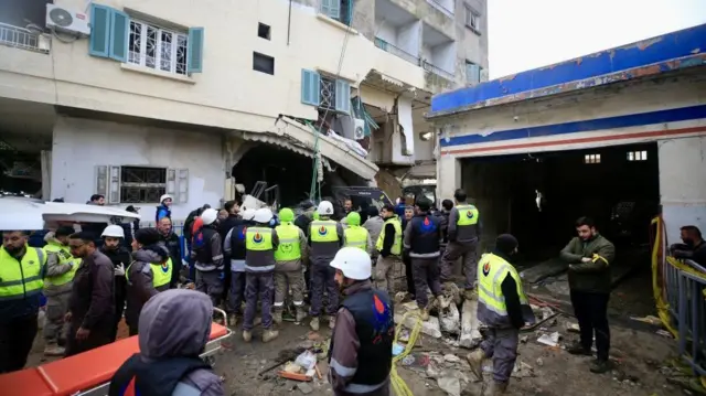 Rescuers work at a damaged building following an Israeli military strike in Nabatiyeh