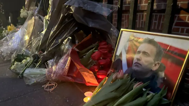 Flowers are laid outside of the Russian embassy in London