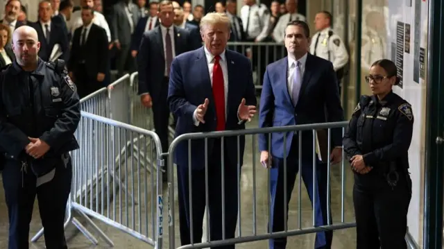 Former U.S. President Donald Trump gestures as he speaks outside the courtroom on the day of a court hearing on charges of falsifying business records to cover up a hush money payment to a porn star before the 2016 election, in New York State Supreme Court in the Manhattan borough of New York City, U.S., February 15, 2024.