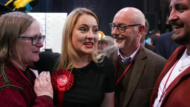 Labour Party candidate Gen Kitchen celebrates with her family after being declared winner in the Wellingborough by-election at the Kettering Leisure Village, Northamptonshire