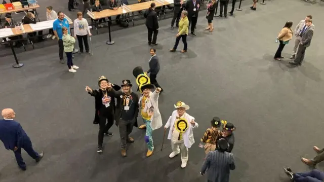 A picture taken from above shows “Nick the Flying Brick”, the candidate from The Official Monster Raving Loony Party, arriving at an election count in Wellingborough