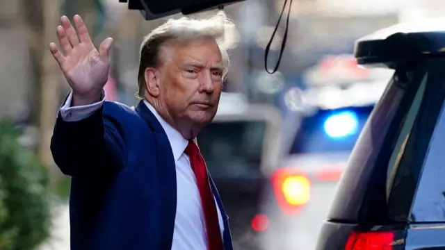 Former U.S. President Donald Trump gestures as he walks outside Trump Tower to attend a court hearing on charges of falsifying business records to cover up a hush money payment to a porn star before the 2016 election, in New York City, U.S., February 15, 2024.