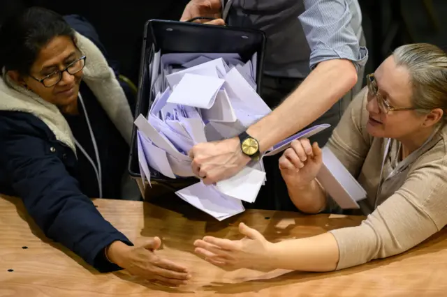 Ballot boxes are emptied at the Wellingborough count