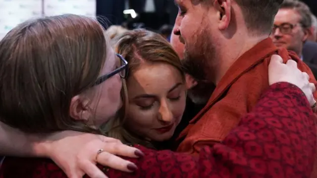 Labour Party candidate Gen Kitchen embraces her family after being declared winner in the Wellingborough by-election