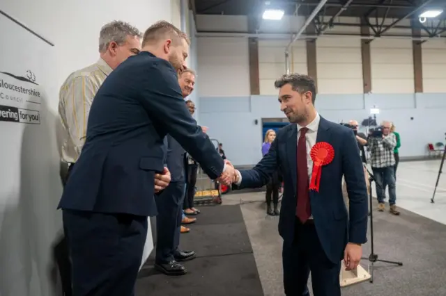 Damien Egan shakes hands with the other candidates after being declared the winner