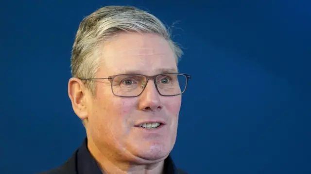 Keir Starmer speaking while wearing glasses