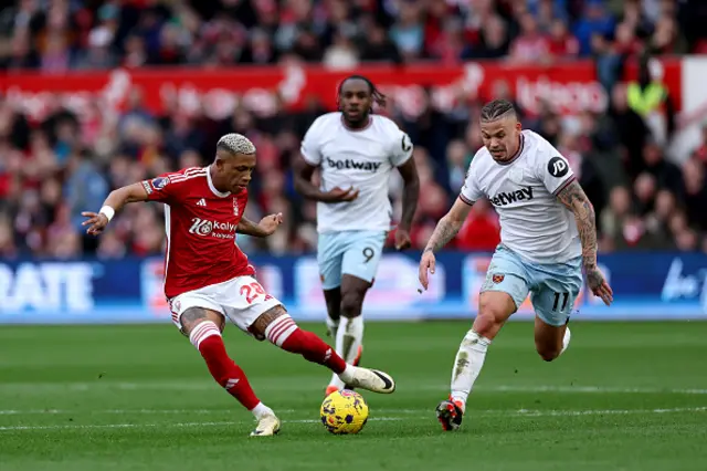 Danilo of Nottingham Forest passes the ball whilst under pressure from Kalvin Phillips