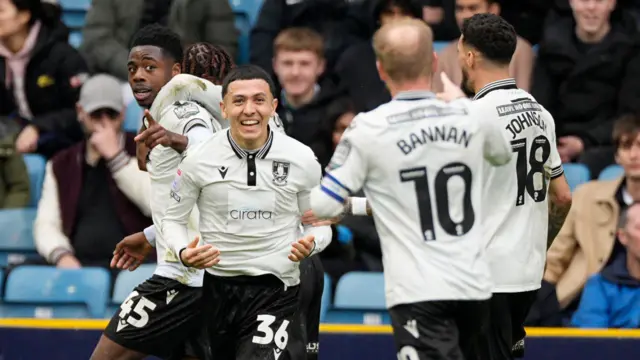 Sheff Wed players celebrate at Millwall