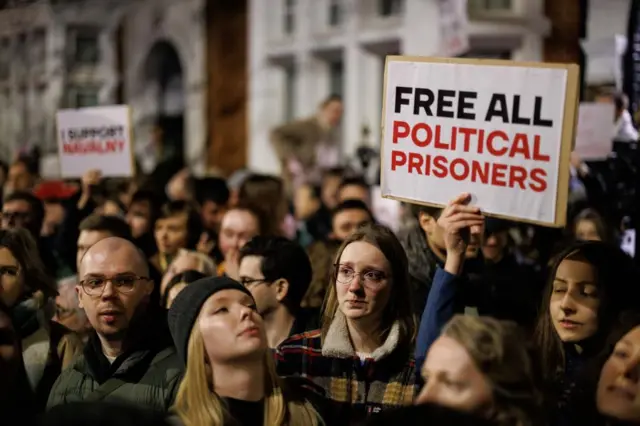 People gather to mourn the late Russian opposition leader Alexei Navalny outside the Russian Embassy in London,