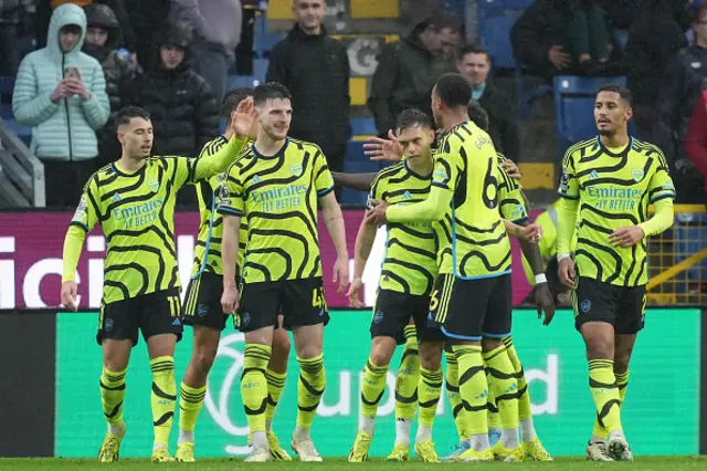 Leandro Trossard (C) celebrates with teammates after scoring their fourth goal