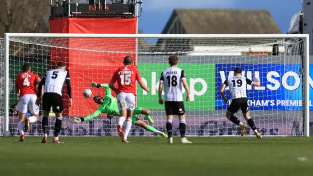 Ben Foster saves a penalty kick for Wrexham against Notts County