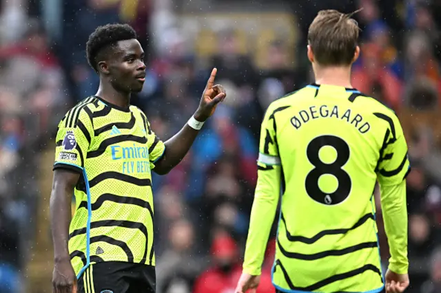 Bukayo Saka of Arsenal (L) celebrates with teammate Martin Odegaard