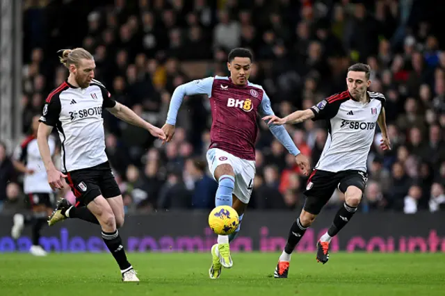 Tim Ream and Timothy Castagne of Fulham battle for possession with Jacob Ramsey