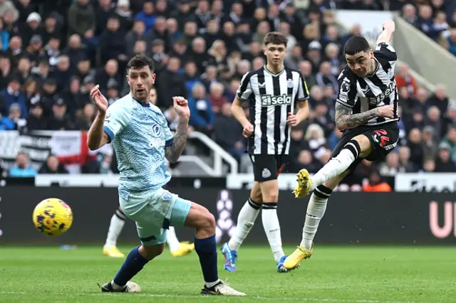 Miguel Almiron of Newcastle United shoots under pressure from Marcos Senesi