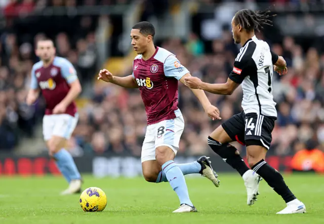 Youri Tielemans of Aston Villa runs with the ball from Bobby Reid