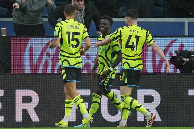 Bukayo Saka celebrates with teammates after scoring their second goal