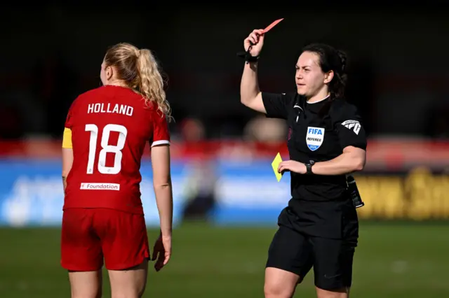 Holland is shown a second yellow and a red card.