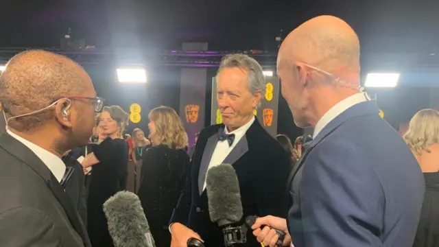 Richard E Grant speaking to the BBC