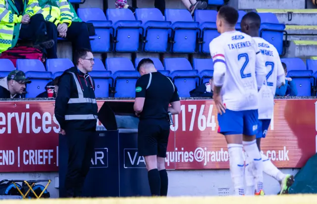 Referee Matthew MacDermid assesses the challenge on the VAR screen