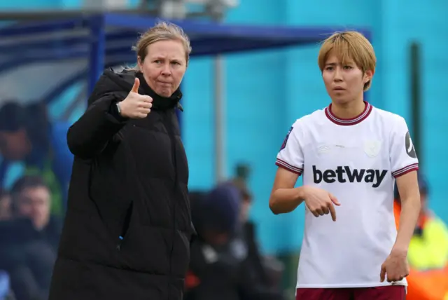 Rehanne Skinner gives a thumbs up to her players from the touchline.