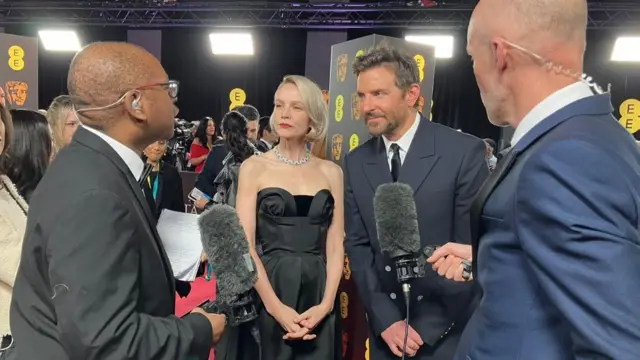 Carey Mulligan and Bradley Cooper take questions on the Bafta red carpet