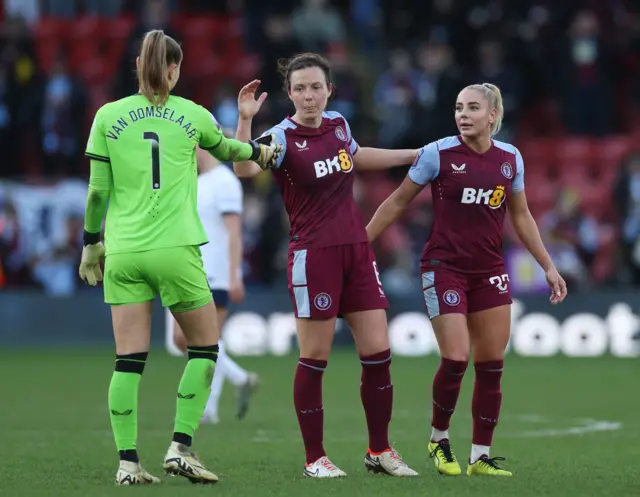 Villa players celebrate on the pitch at full time.