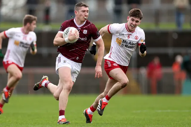 Johnny Heaney attempts to speed away from Niall Devlin in Omagh