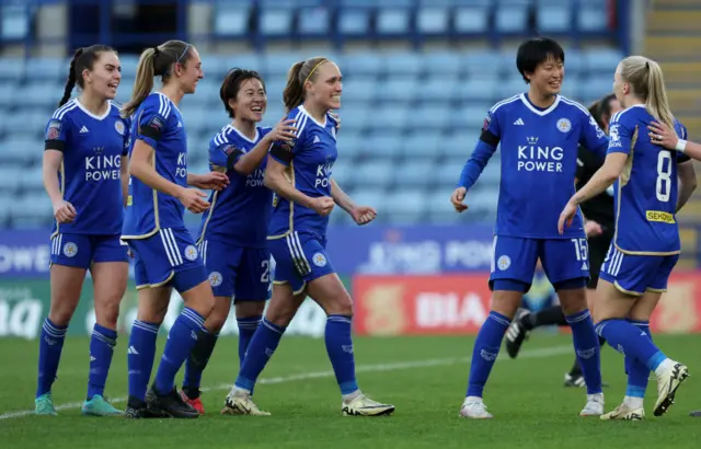 Cayman is congratulated by teammates after re-establishing Leicester's lead.