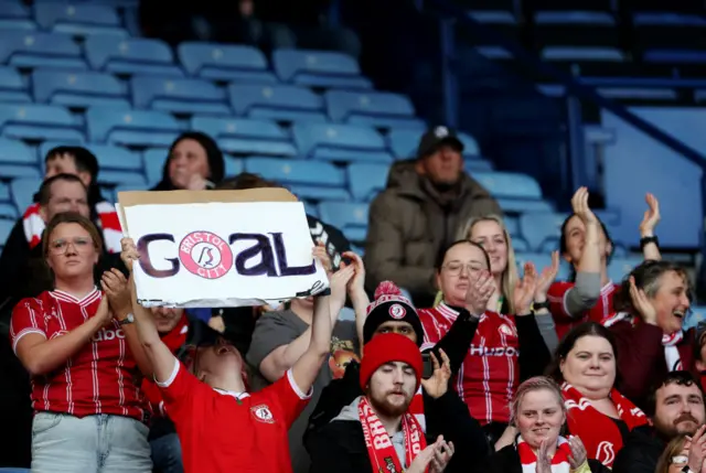 A Bristol fan holds up a sign with 'goal' after her side open the scoring at Leicester.