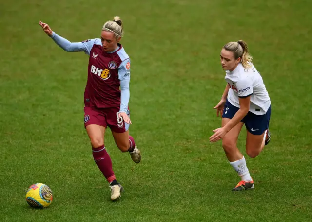 Nobbs runs away from Clinton in midfield.