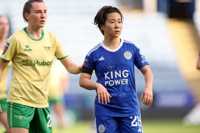 Momiki waits for a pass into the box while being marked.