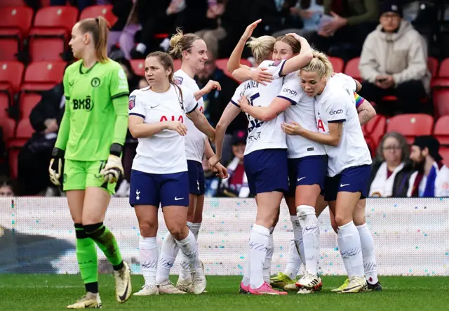 Turner celebrates with teammates after equalising for Spurs.