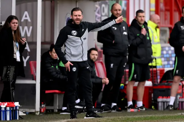 Harris gives instructions to Brighton on the touchline.