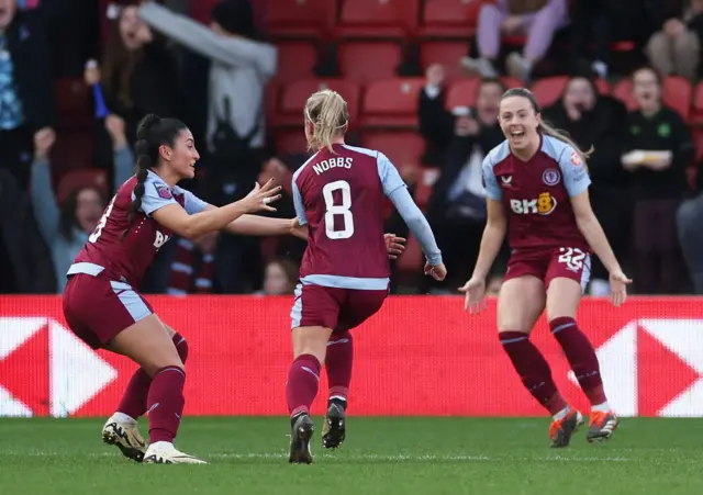 Nobbs runs to celebrate her long range goal which put Villa in the lead at Spurs.