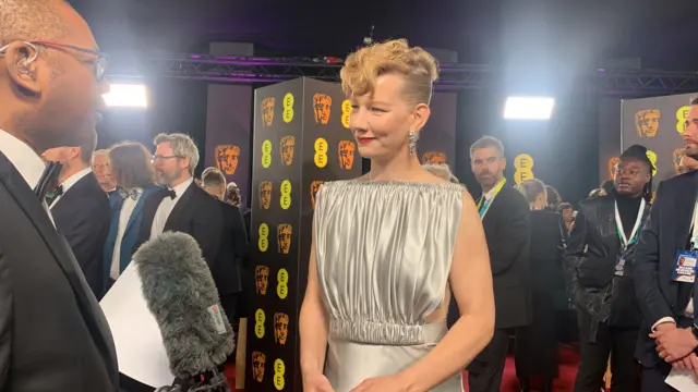 Sandra Huller on Baftas red carpet with Lizo