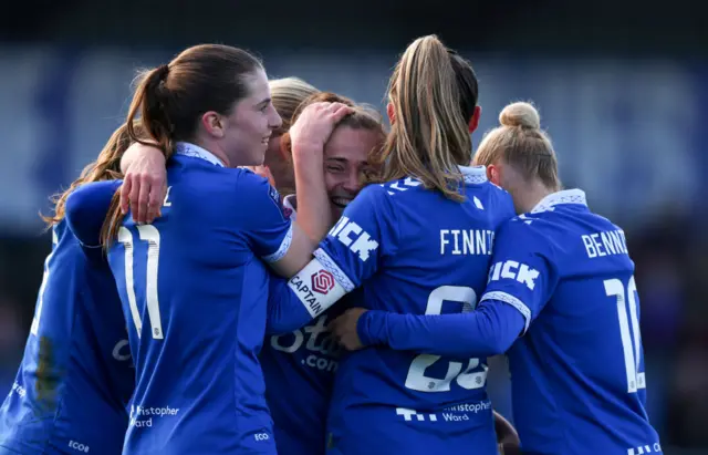 Galli is mobbed by teammates after doubling Everton's lead.