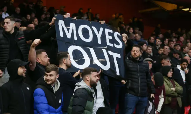 West Ham United fans lift a banner with the message MOYES OUT, calling for David Moyes to be sacked during the Premier League match between Nottingham Forest and West Ham United