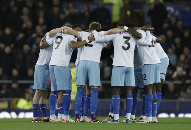 Crystal Palace huddle in the pitch