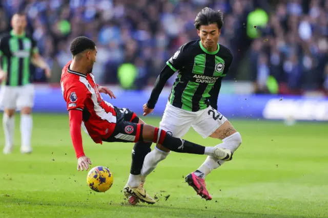 Mason Holgate fouls Kaoru Mitoma