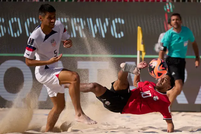 Mohamed Loha of Egypt being followed by Nicolas Perea of USA during the FIFA Beach Soccer World Cup UAE 2024 Group A match