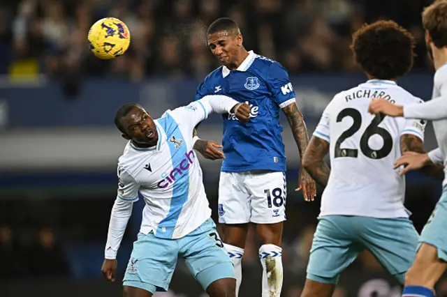 Ashley Young heads the ball