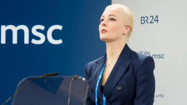 Yulia Navalnaya, a blonde woman, speaks at a lectern at the Munich Security Council