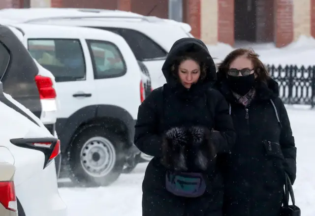 Lyudmila Navalnaya (R), mother of Alexei Navalny, walks accompanied by lawyers after visiting the Investigative Committee in Salekhar