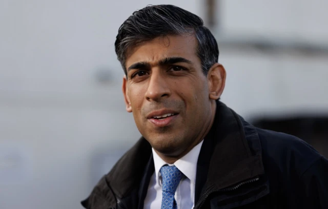 Prime Minister Rishi Sunak speaking to the media while visiting Harlow Police Station in Essex