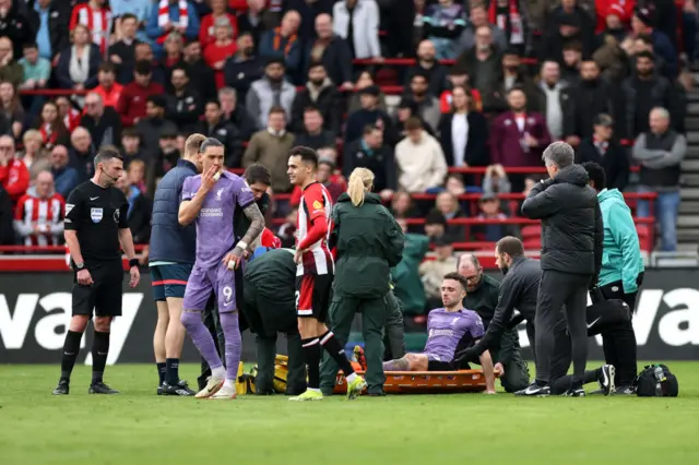 Diogo Jota of Liverpool is stretchered off after a challenge with Christian Norgaard (not pictured) during the Premier League match between Brentford FC and Liverpool FC