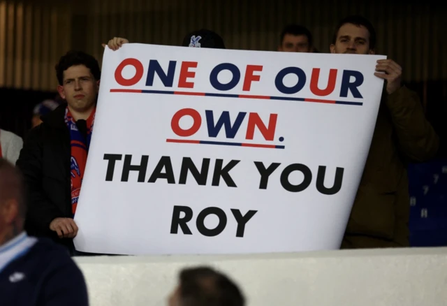 Crystal Palace holds a sign in support of previous manager Roy Hodgson