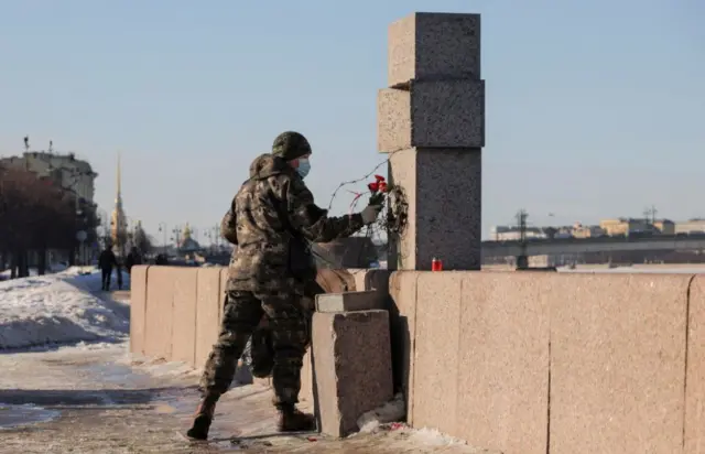 People lay flowers to honour the memory of Alexei Navalny in St Petersburg