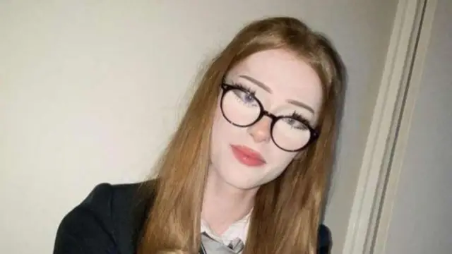 Brianna Ghey in school uniform and glasses