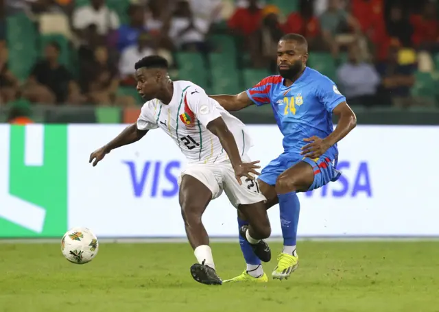 Guinea's Sekou Sylla in action with DR Congo's Gedeon Kalulu